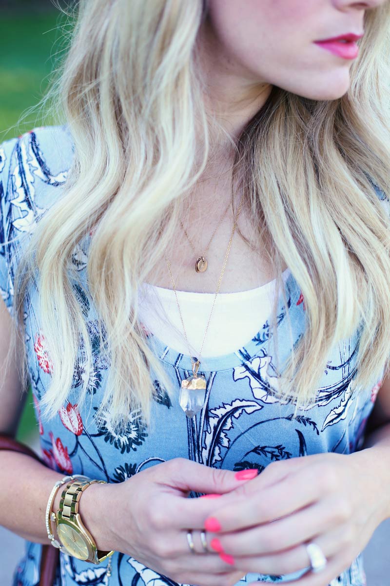 It's in the details. Abby wears a quartz necklace paired with gold accessories.