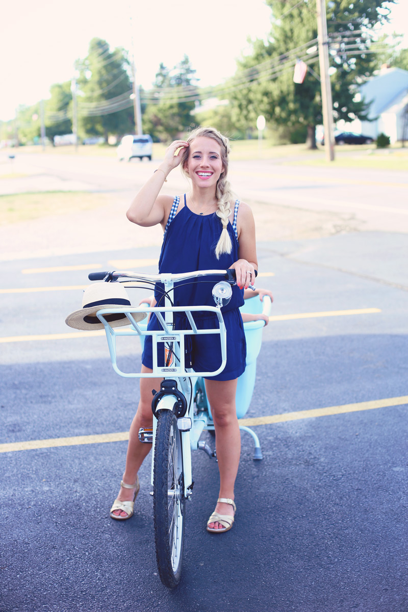 Abby pedals the Bucket Bike, wearing a blue romper.