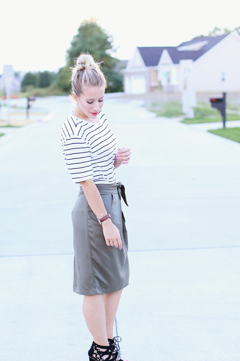 Abby wears a white top with black stripes and a gray skirt. Twist Me Pretty. Sunday style