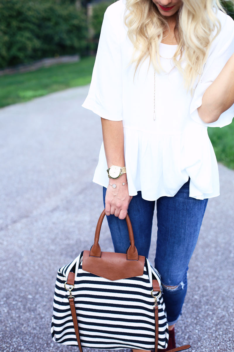 A woman shows off her handbag and accessories while she enjoys motherhood. Twist Me Pretty.