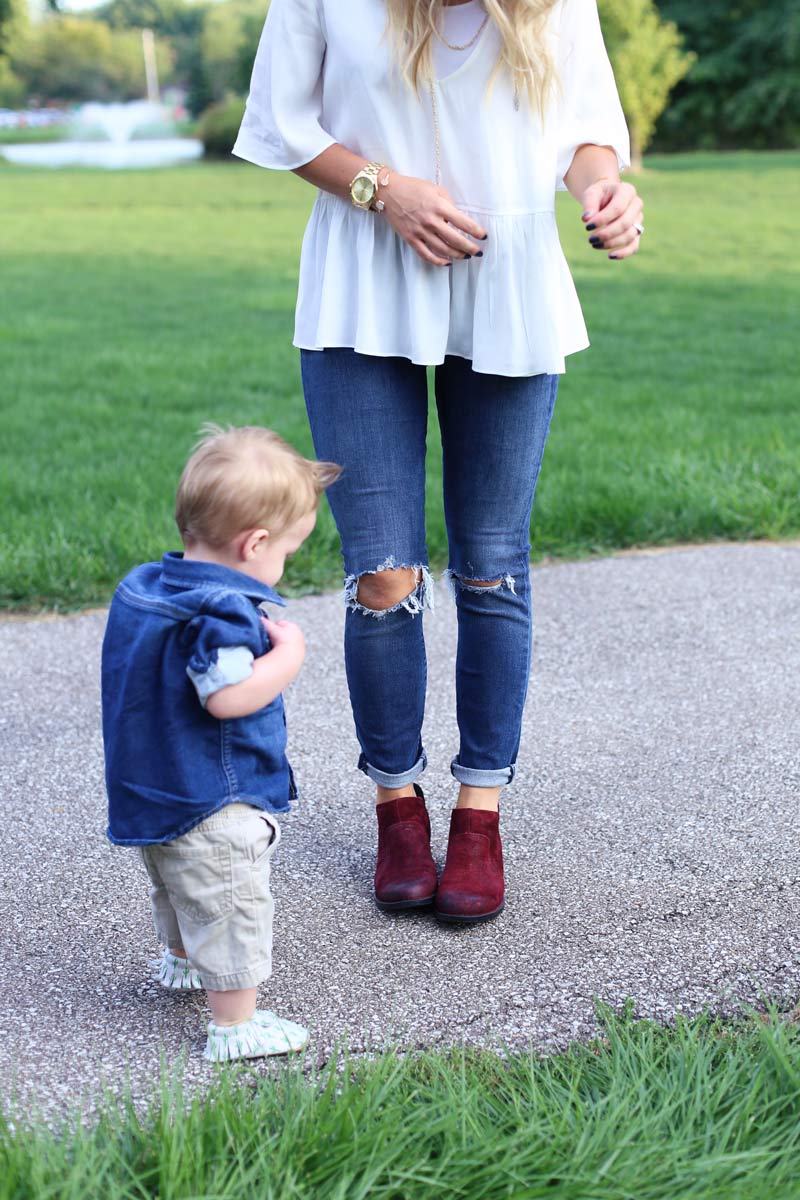 A little boy stands and looks at his mother's feet, as she enjoys motherhood. Twist Me Pretty.