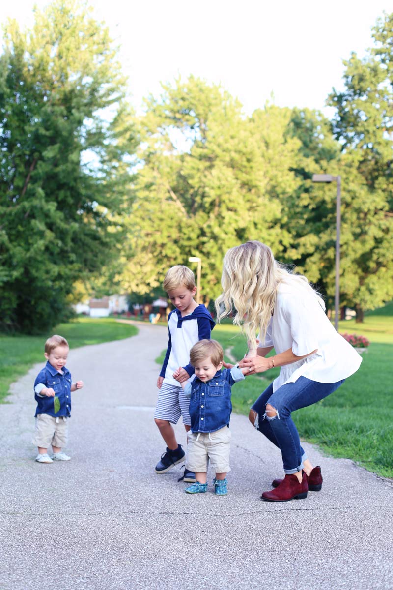 A mother and her three sons in a park. Enjoy motherhood. Twist Me Pretty.