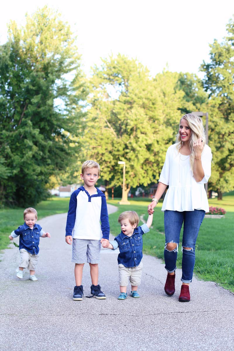 A mother stands in a line with her three sons in a park. Twist Me Pretty. Enjoy motherhood