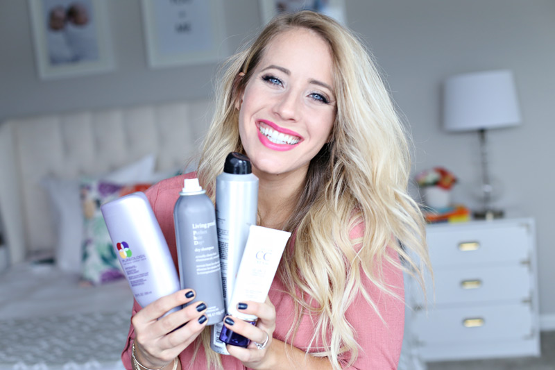 Displaying an array of products, a woman with gorgeous hair smiles at the camera. Twist Me Pretty.