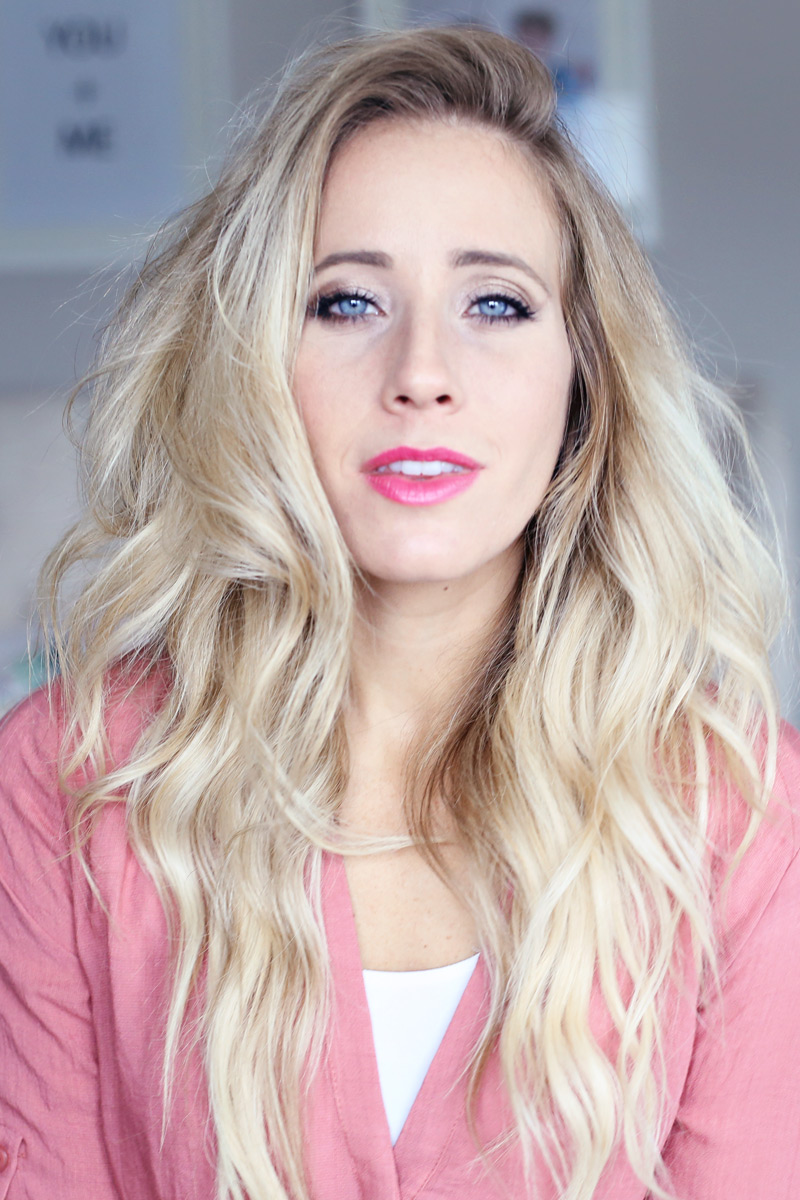 With tousled hair, a blonde woman gazes into the camera. You too can have gorgeous hair. Twist Me Pretty.