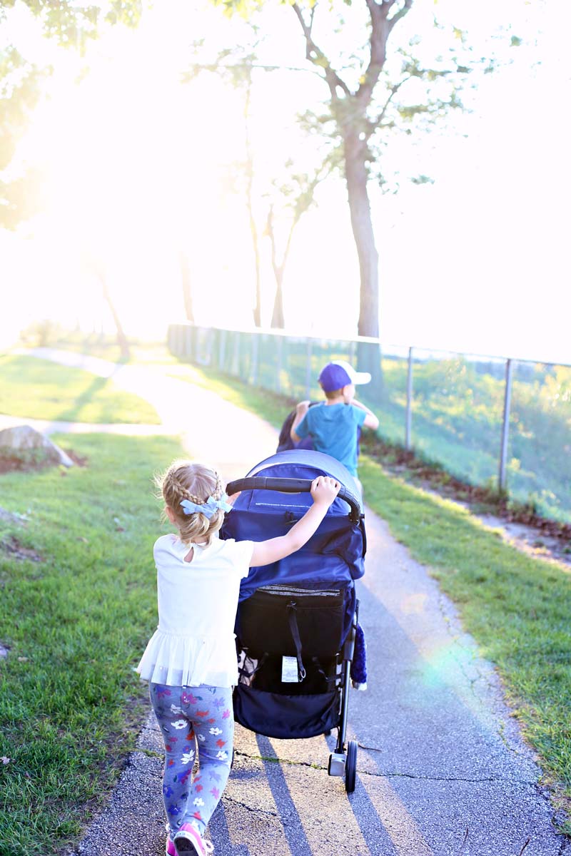 Family walks - big kids pushing the little ones in strollers.