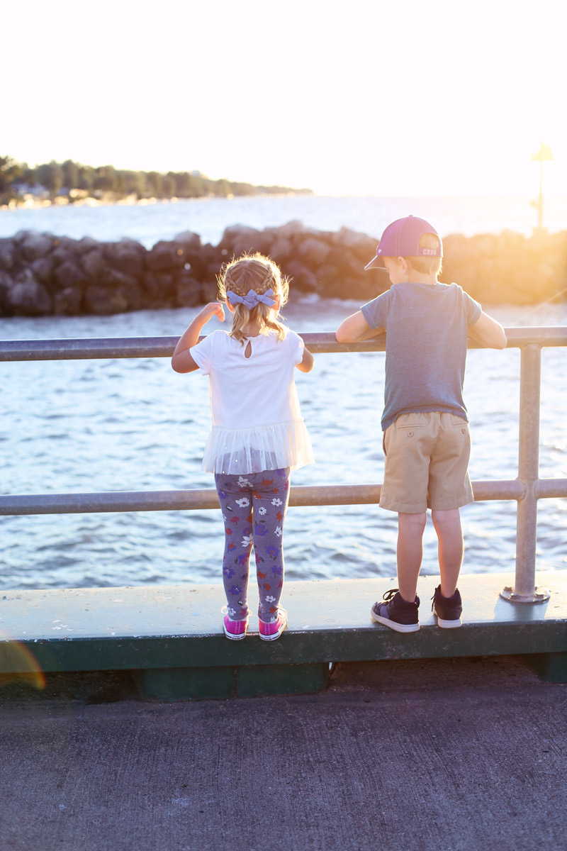 Boston and Savy peer over the edge of the pier.