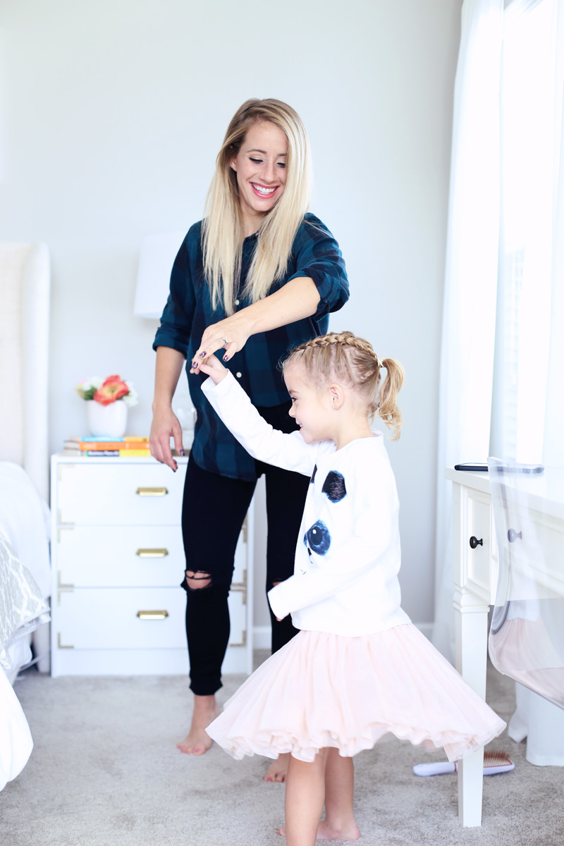 A mother and daughter grin as they dance together. Twist Me Pretty - Our Morning Routine.