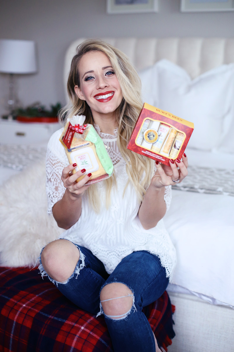 Twist Me Pretty's Abby holds up Burt's Bees' holiday gift sets.