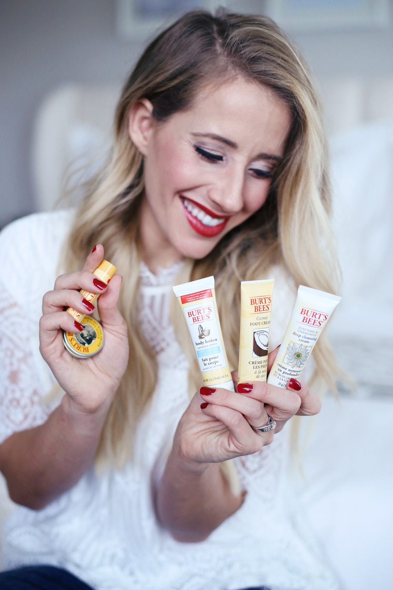 Abby from Twist Me Pretty smiles as she displays products from Burt's Bees' holiday gift sets!