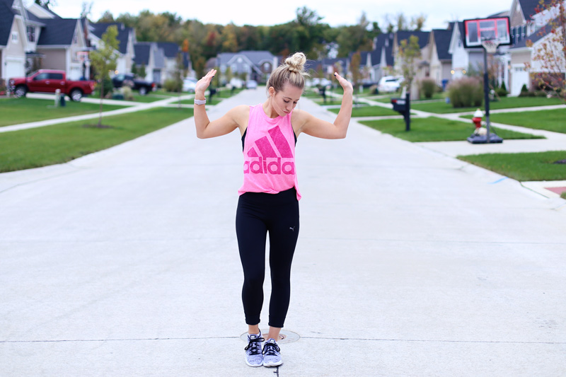 A woman dances in the middle of the road. She is staying in shape. Twist Me Pretty. 