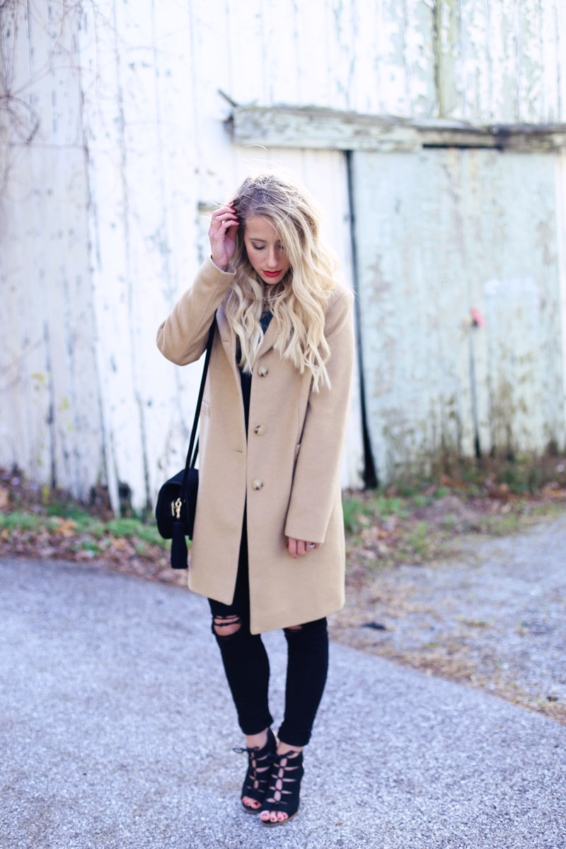 Abby looks at the ground as she stands in the middle of a street. Twist Me Pretty.