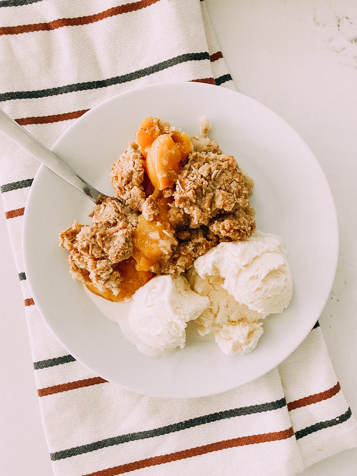 There is nothing better than my easy peach cobbler recipe served warm with ice cream! www.twistmepretty.com